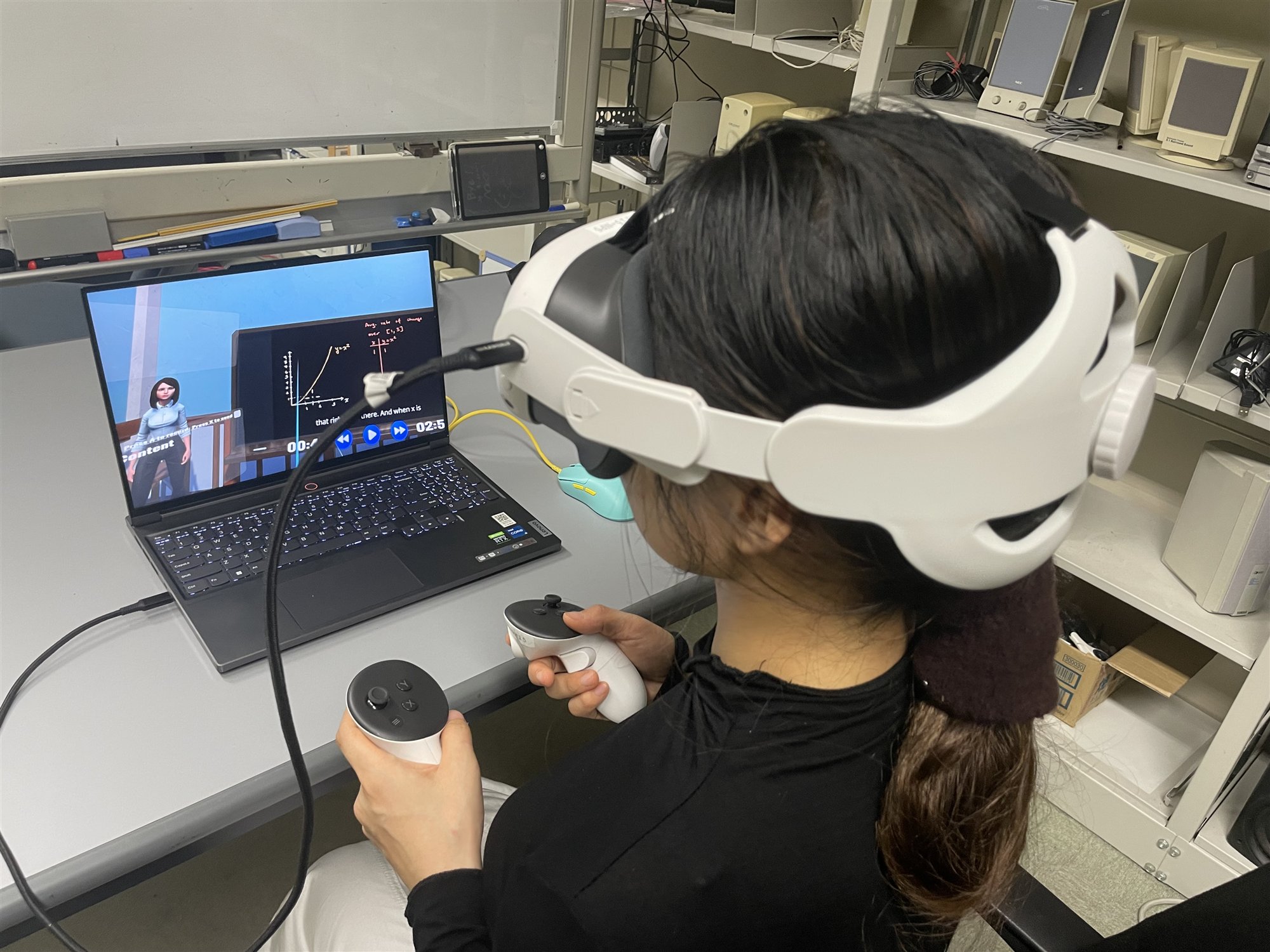 A study participant wearing a Meta Quest 3 headset while seated in front of the desktop study station